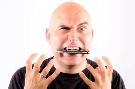 Bald guy eating mobile phoneの写真素材