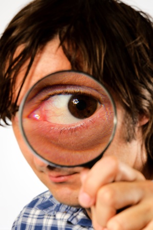 man looking through magnifying glassの写真素材