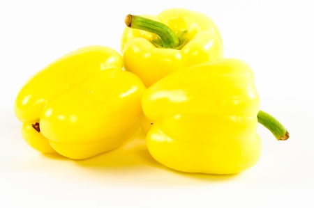 Yellow organic peppers isolated on white の写真素材