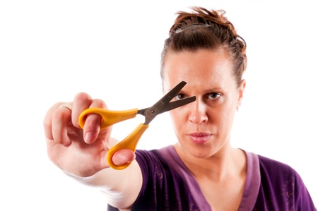 Woman with the scissors isolated on whiteの写真素材