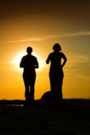 Couple meditating in the sunの写真素材