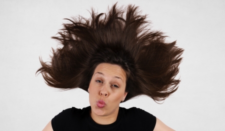 Female with splashed hair giving the kissの写真素材