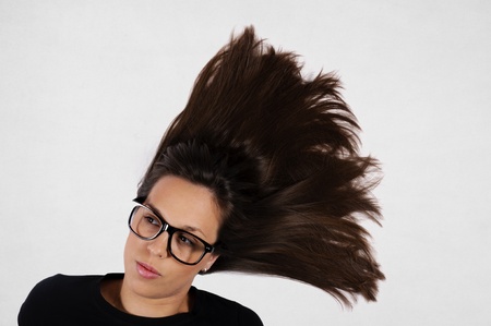 Female with the splashed hair on gray backgroundの写真素材
