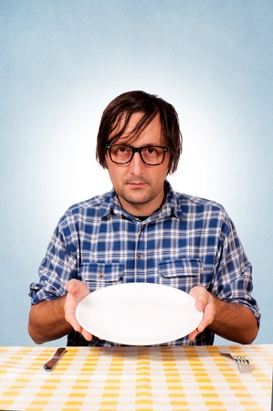 A hungry man showing the empty plateの写真素材