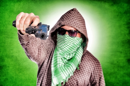 Selective focus on the hand and gunの写真素材