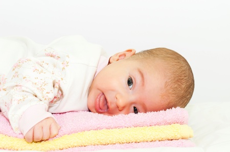 Happy baby girl on the towels