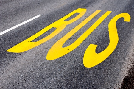 Yellow bus sign on the roadの写真素材