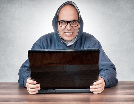 Angry man holding the lap topの写真素材