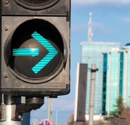 Traffic light showing the green arrow. Selective focus on the green arrow