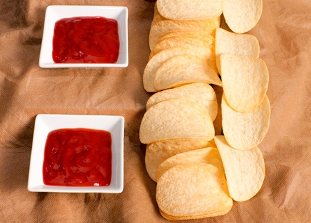 Potato chips and ketchup shoot in low key technique