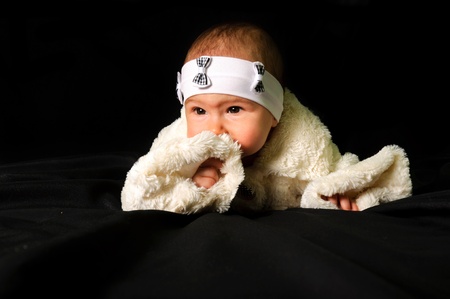 Cute baby on black background thinking. の写真素材