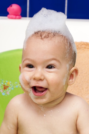 Baby with the foam on her headの写真素材