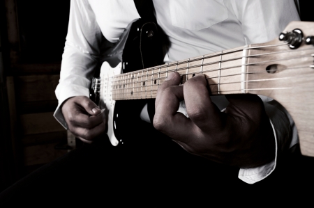 Businessman playing guitar in low keyの写真素材
