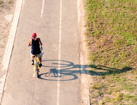 Man on bicycle on hot summer dayの写真素材