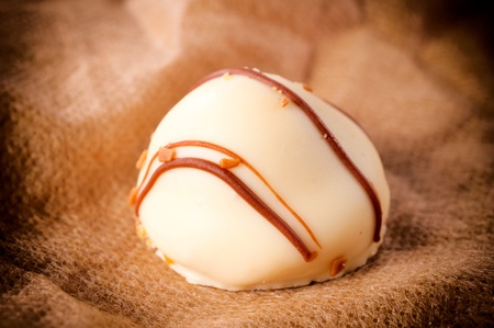 Single white chocolated praline in low key の写真素材