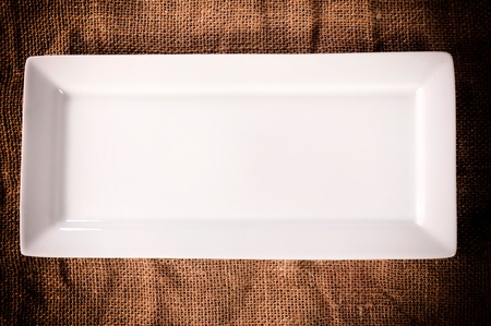 Empty white plate on the abstract background from above の写真素材