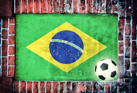 Brasilian flag with football ball on the old bricks wallの写真素材