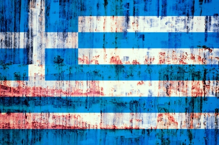 Old Greece flag on the rusty and metal wallの写真素材