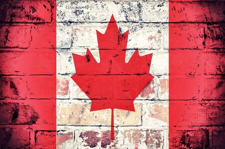 Grunge flag of Canada on the old wallの写真素材
