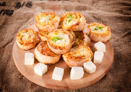 Melted cheese pie on the wooden board 
