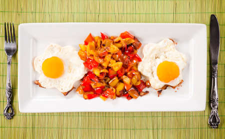 Set up with fried eggs and sliced peppers from aboveの写真素材