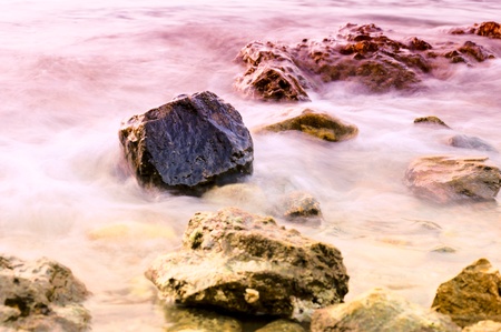 Water and stones in long exposure.Selective focus on stone in the middle 
