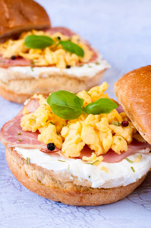 Scrambled eggs,ham and white cheese cream on the bunの写真素材