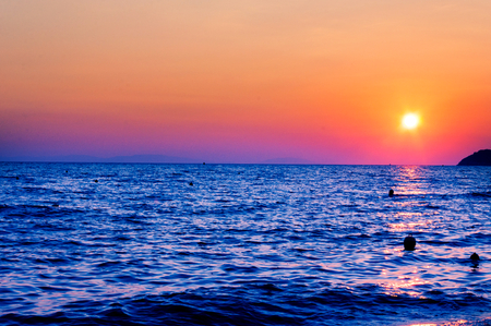 Sunset over the dark blue sea の写真素材