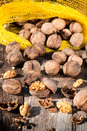 Splashed walnuts on the wooden table の写真素材