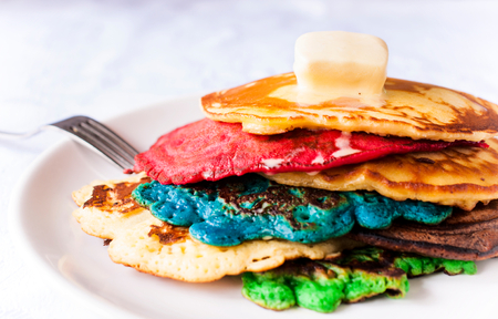 Homemade colorfull pancakes with melted butter on the topの写真素材