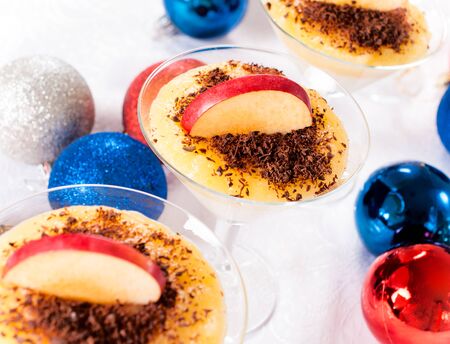 Semolina pudding and slice of the apple in fancy glass.Selective focus in the middle の写真素材