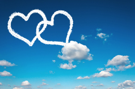 Heart clouds shape on the clear blue skyの写真素材