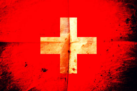 Old creased paper with Swiss flagの写真素材