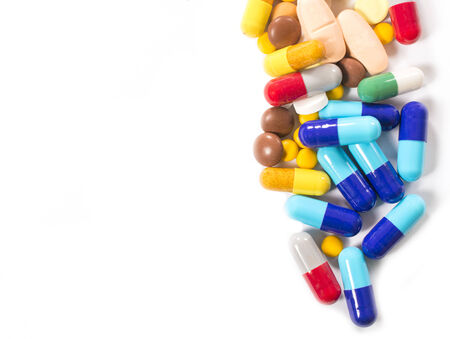 Bunch of pills on white background with blank space for text on left side