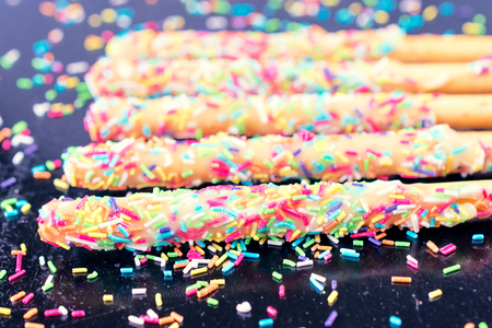Selective focus on the front baked stick with colourful crumbs 