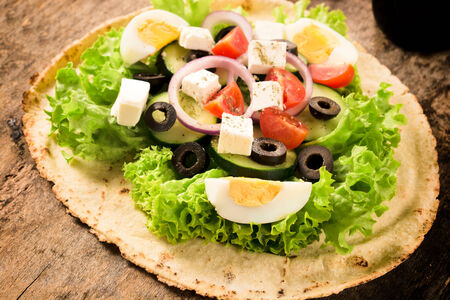 Tortilla bread with fresh spring salad, vegetables and cheeseの写真素材
