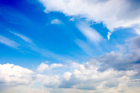 White fluffy clouds and the blue sky as background 