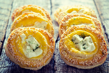 Fresh baked pastry with melting cheese on top.Selective focus on the front pastryの写真素材