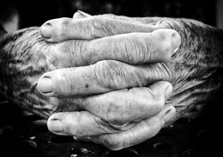 Very old woman holding her hands together,black and white Selective focus on the front part of handsの写真素材