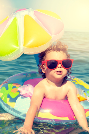 Little child enjoy in the summer time at seasideの写真素材