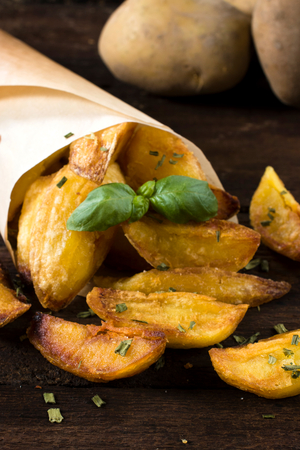 Selective focus on the front baked potatoes with chive 