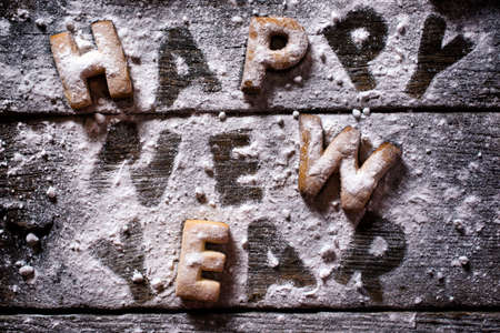 Happy New Year text with cookies on the wooden background の写真素材