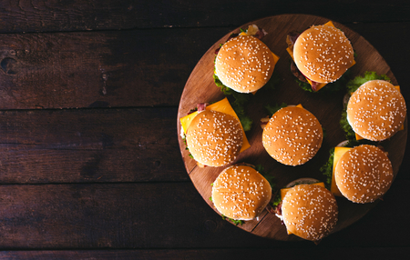 Group of beef burgers on the wooden background,from above and selective focus.Blank space on the left side の写真素材