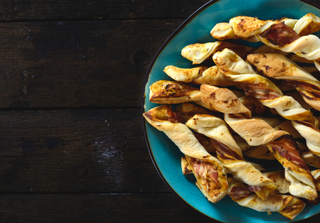 Bacon pastry on the wooden background with blank spaceの写真素材