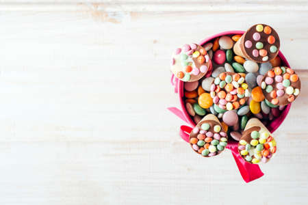 Ice cream with colorful bonbons from above on white wooden background with blank space,selective focusの写真素材