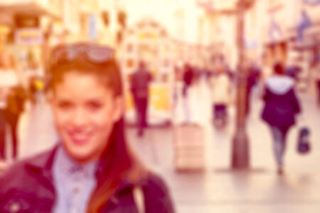 Blurred image of female and people in the cityの写真素材