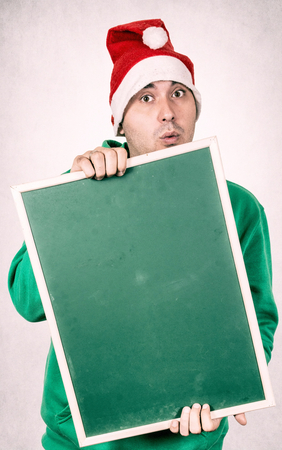 Positive santa holding blank chalk boardの写真素材