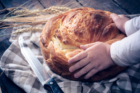 Little child holding homemade bannock breadの写真素材