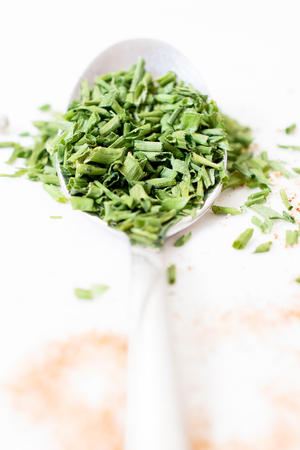 Sliced chive onion in the metal spoon,selective focusの写真素材