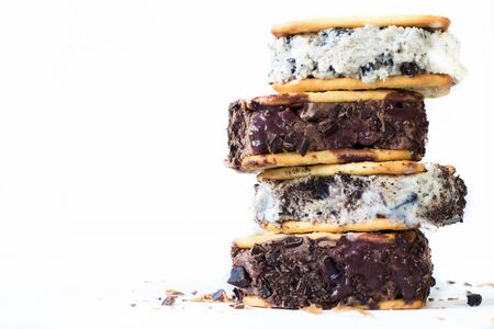 Stracciatella and chocolate ice creams batween crackers on white background with blank spaceの写真素材